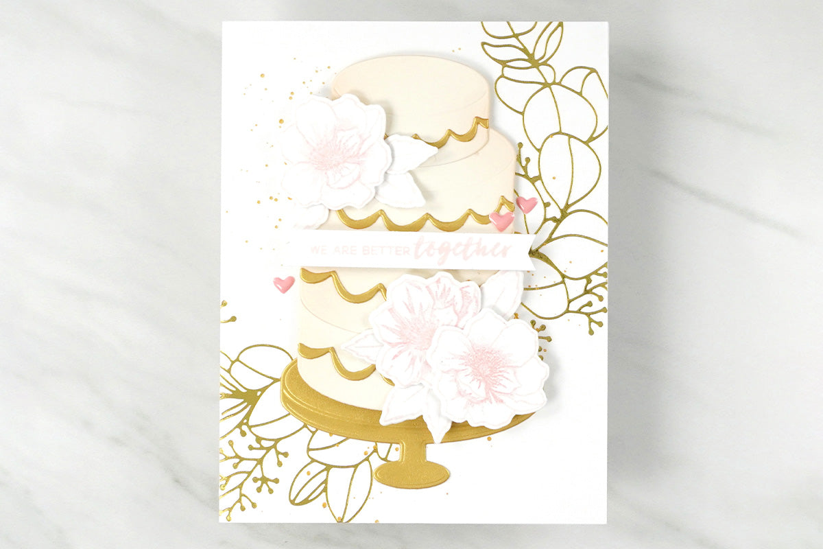 Elegant wedding card with a foiled eucalyptus wreath and a huge wedding cake design