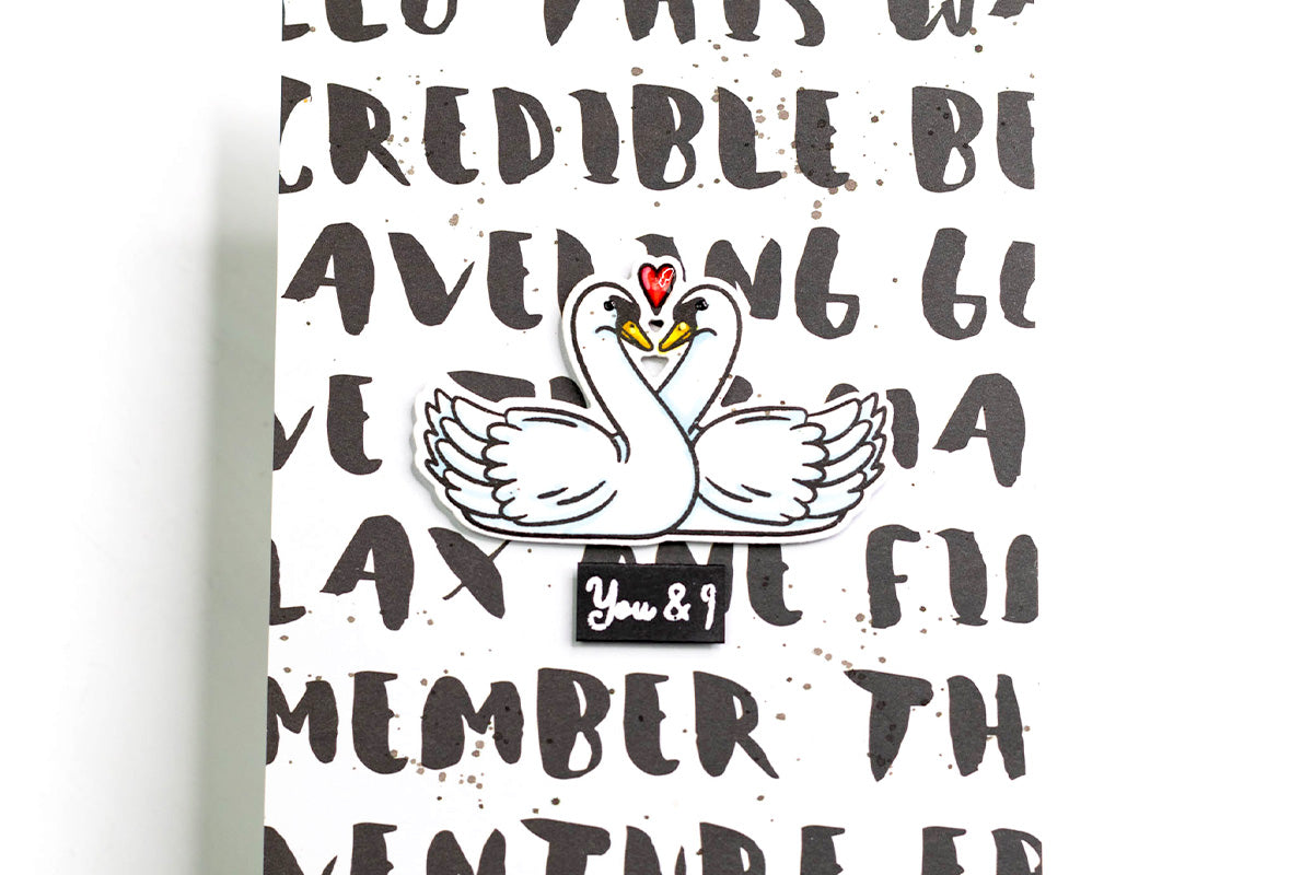 DIY anniversary card featuring stamped sentiment background and sweet swans