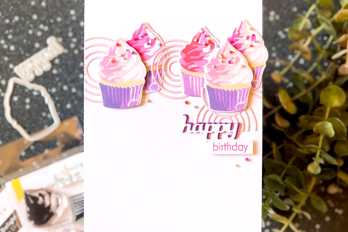 Cute birthday card with die-cuts of pink and purple cupcakes