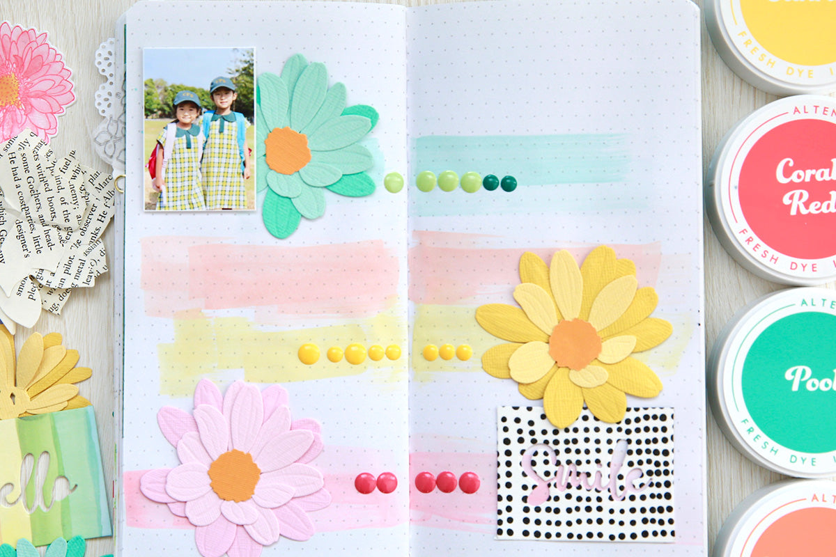 Colorful scrapbooking page idea with floral die-cuts, enamel dots and dye ink swipes
