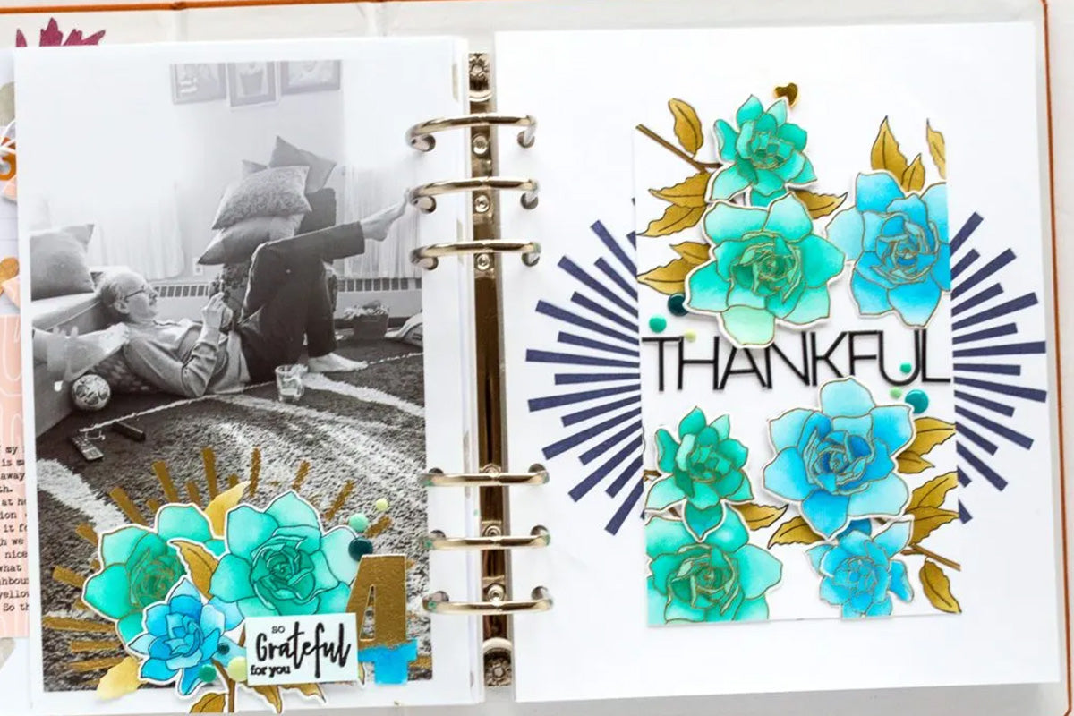 DIY masculine scrapbook layout with blue flowers and gold embossed elements