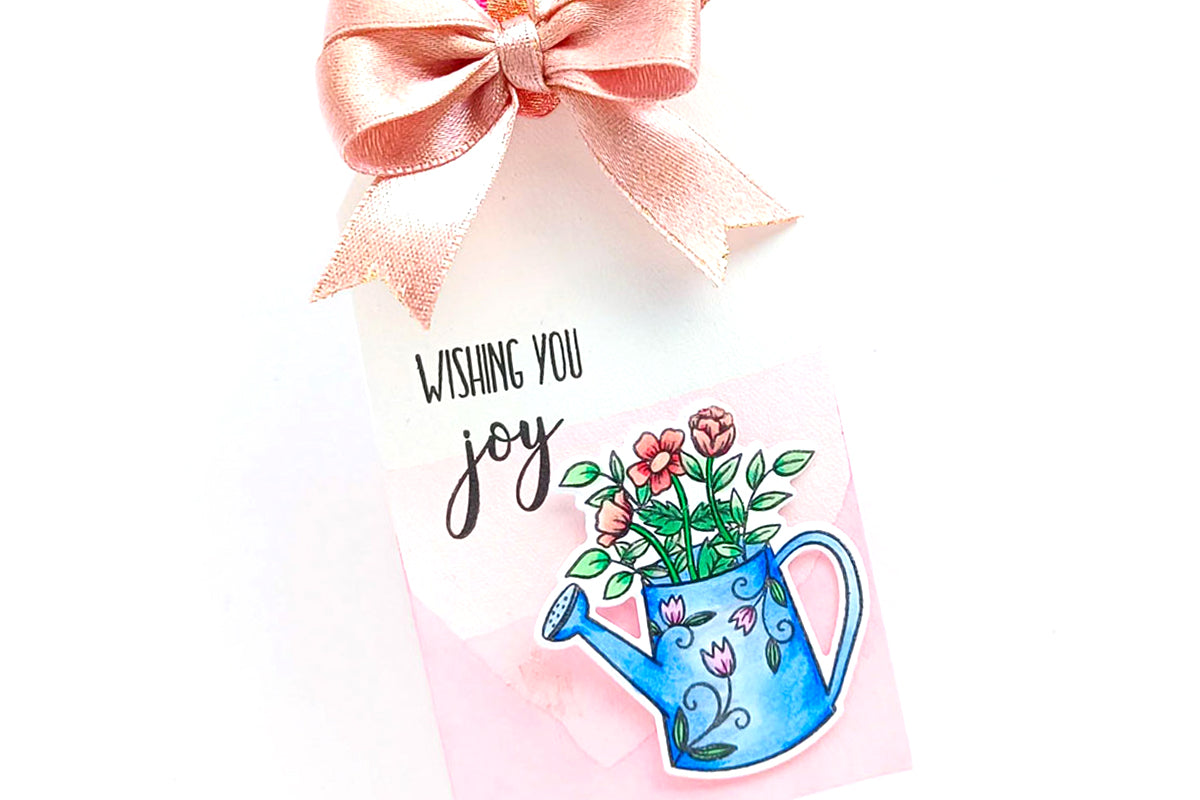 DIY tag with a cute dainty watering can and a pink ribbon