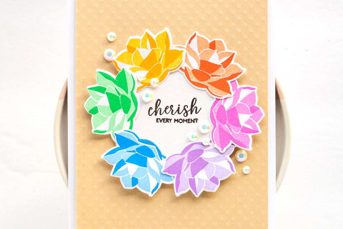 Colorful handmade card with a wreath design and embossed background