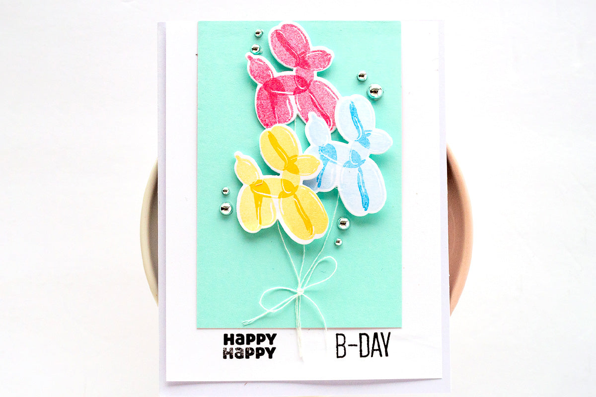 Cute birthday card with die-cuts of colorful balloon animals