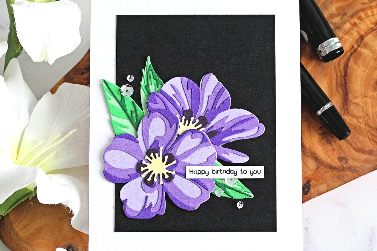 A birthday card created from purple colored cardstock and a black background