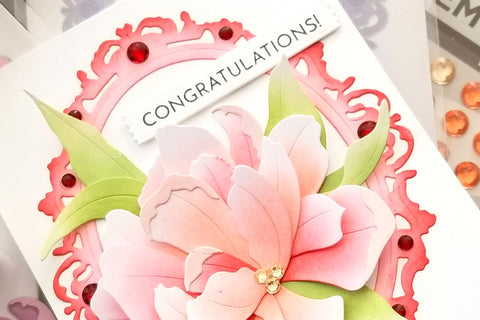 A congratulatory greeting card with a luscious floral bloom, designed with the Sparkled Frame Die and some Red Jasper Gem Sparkles