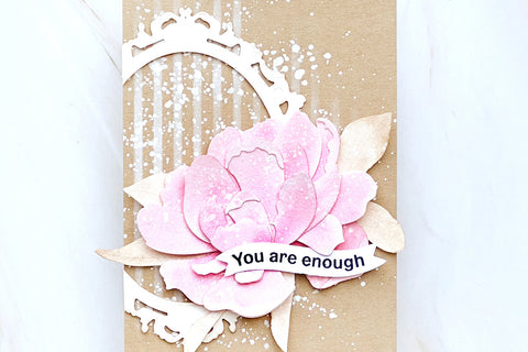 A clean-and-simple "you are enough" card with a pink floral blossom designed with the Sparkled Frame Die on top of kraft paper.