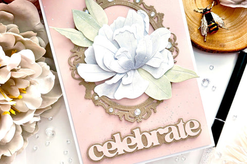 A "celebrate" card designed with the Sparkled Frame Die and a white blooming flower as a focal point