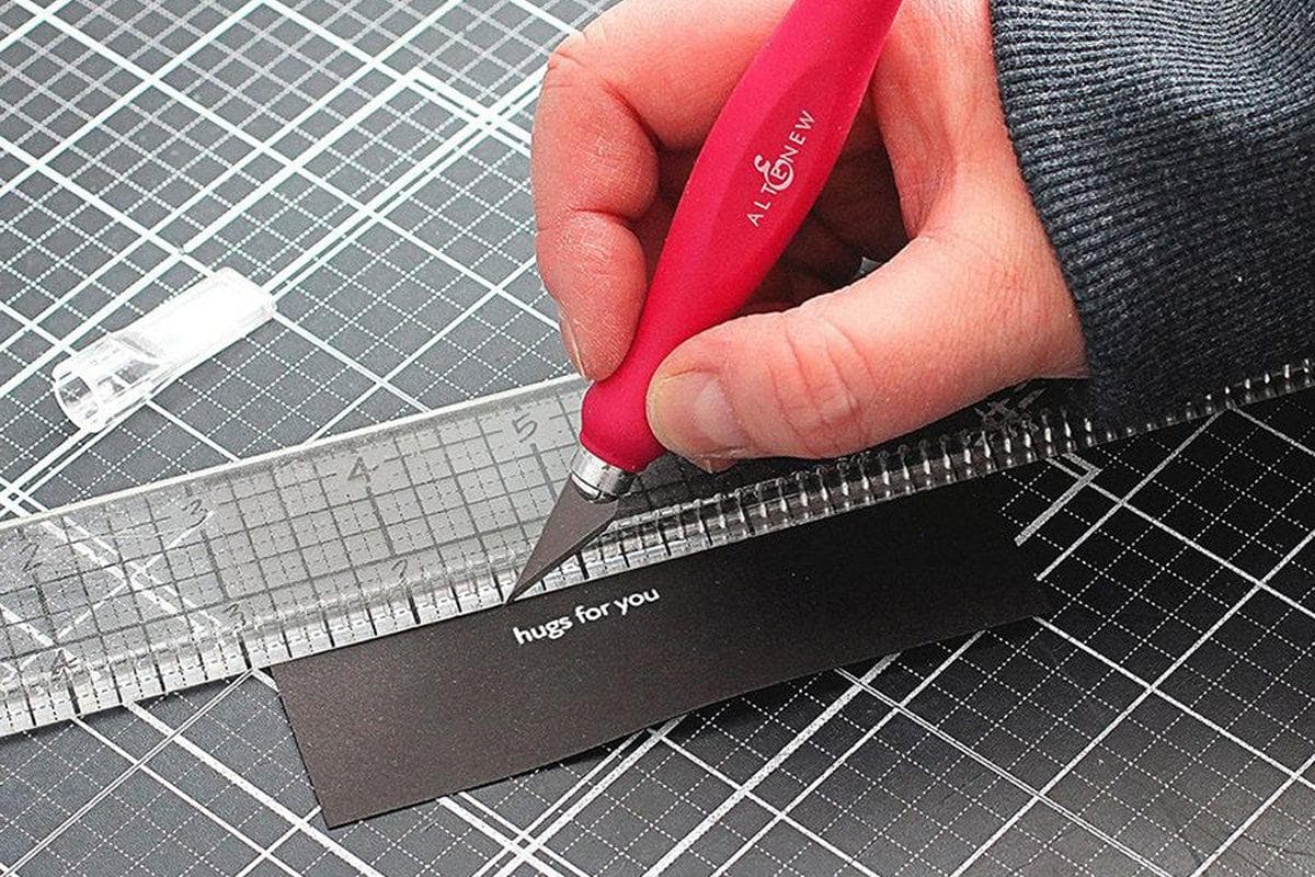 Using the Comfy Cut Ergonomic Craft Knife to cut out a sentiment from black cardstock