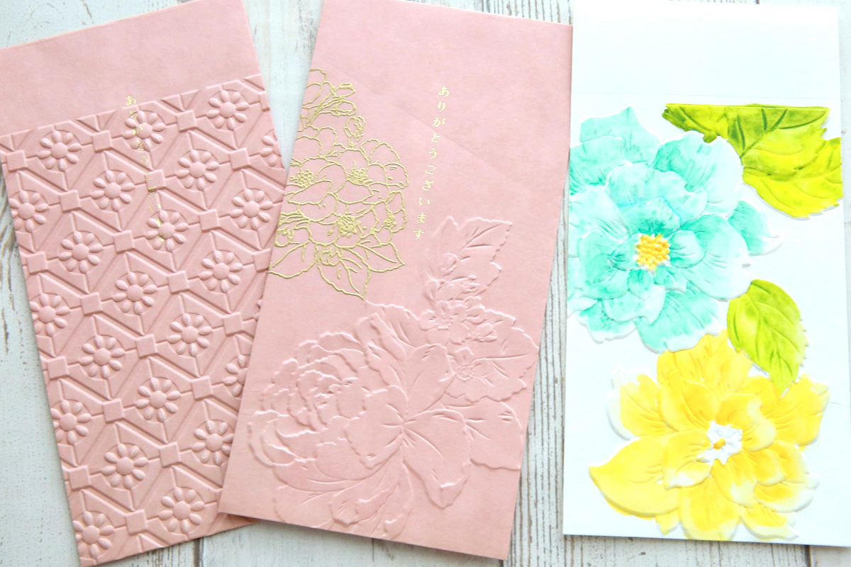Two 5x7 greeting card envelopes customized with 3D embossing folders and watercolors