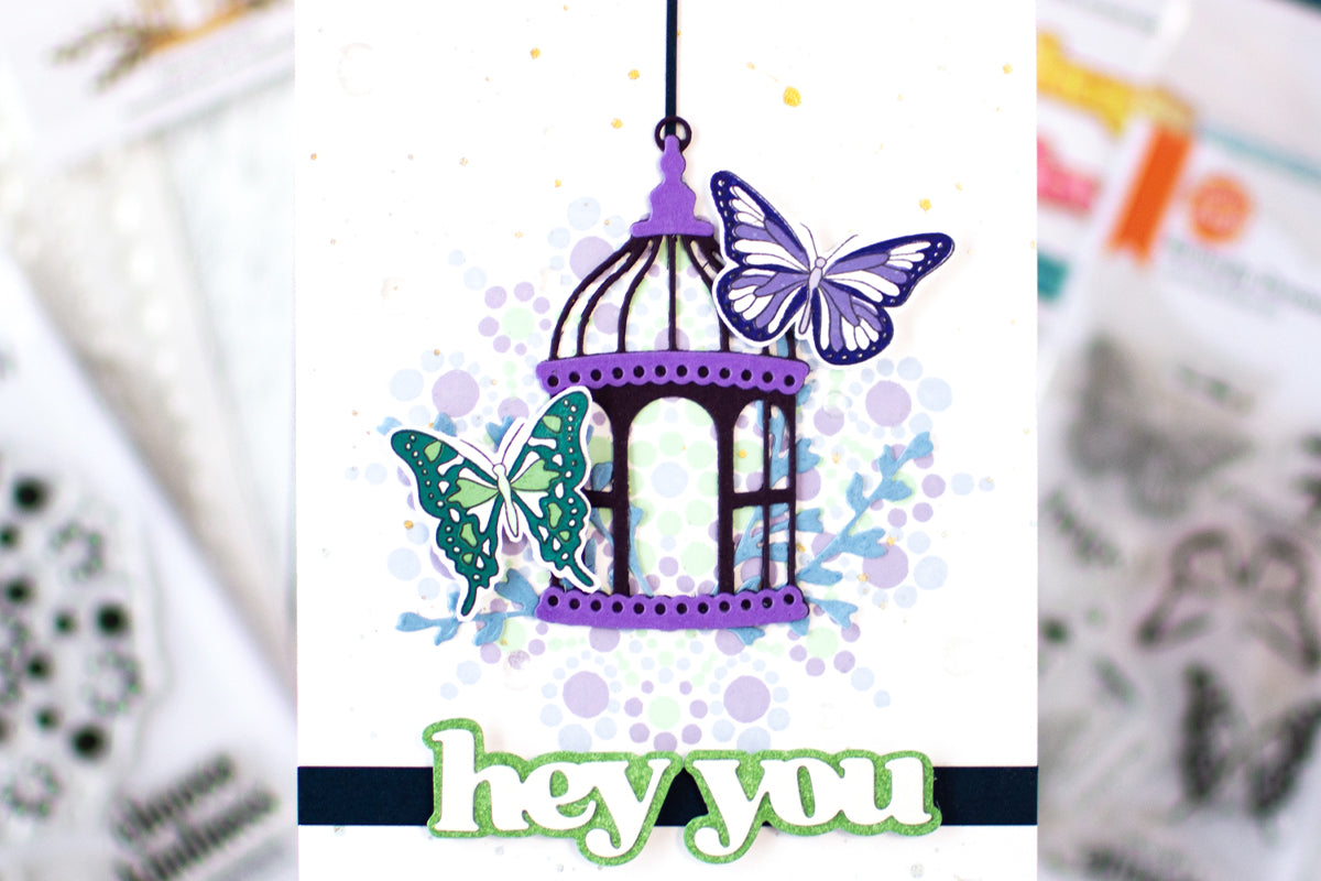 Pastel butterfly greeting card with 2 butterflies, a bird cafe and a dotted mandala design in the background