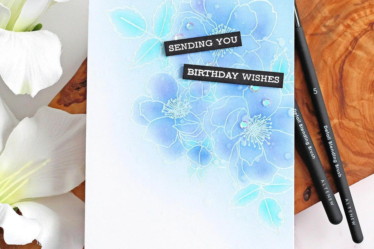 A birthday card with a subtle but gorgeous blue background, colored in with Altenew's Detailed Blending Brush