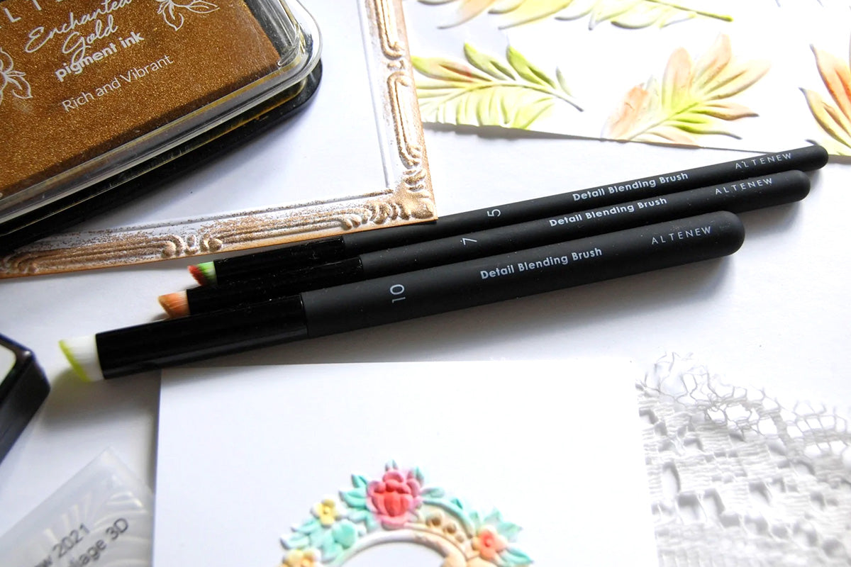 Altenew's Detailed Ink Blending Brushes beside cards and other crafting tools