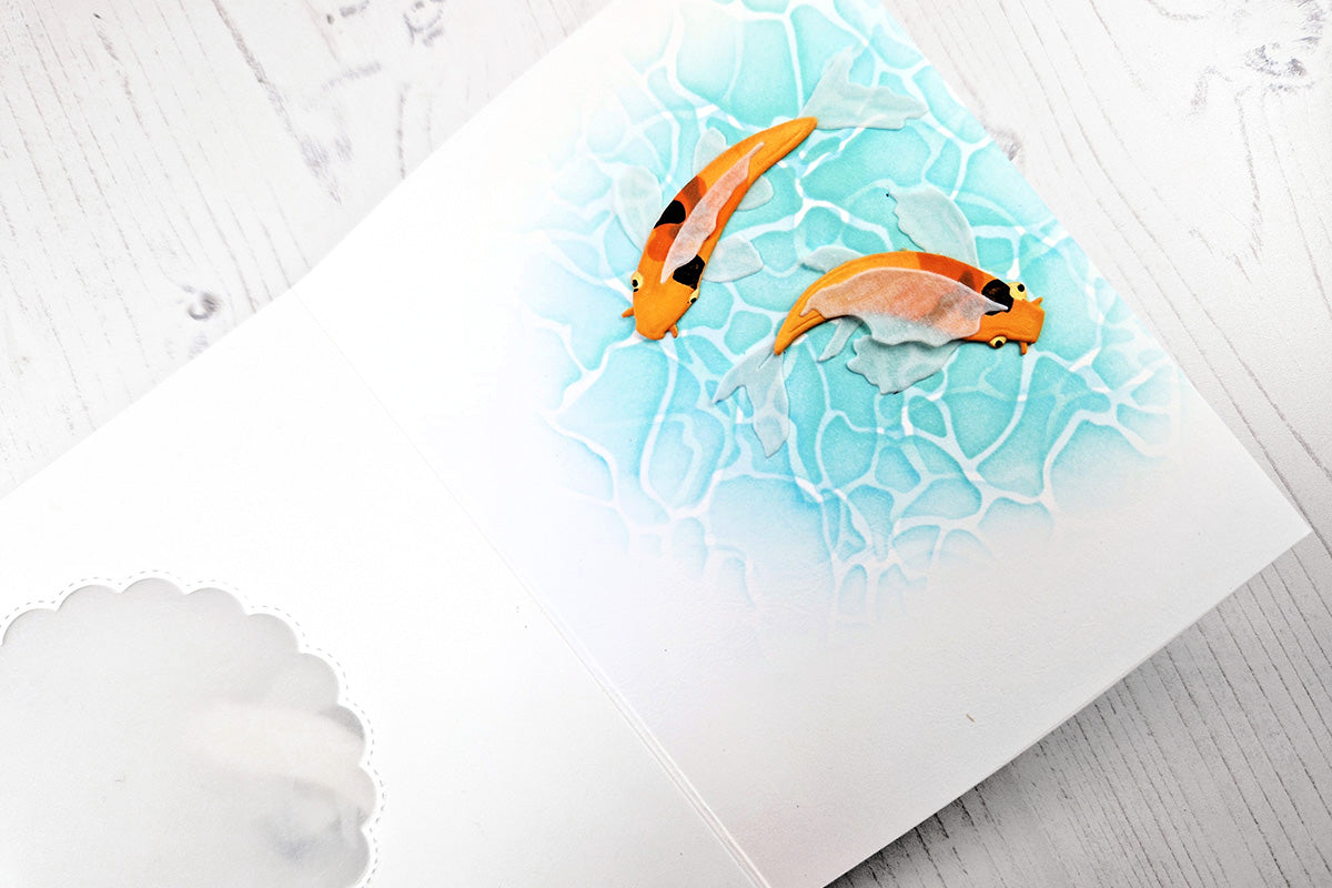 Stenciled water background inside a greeting card with 2 koi fish images