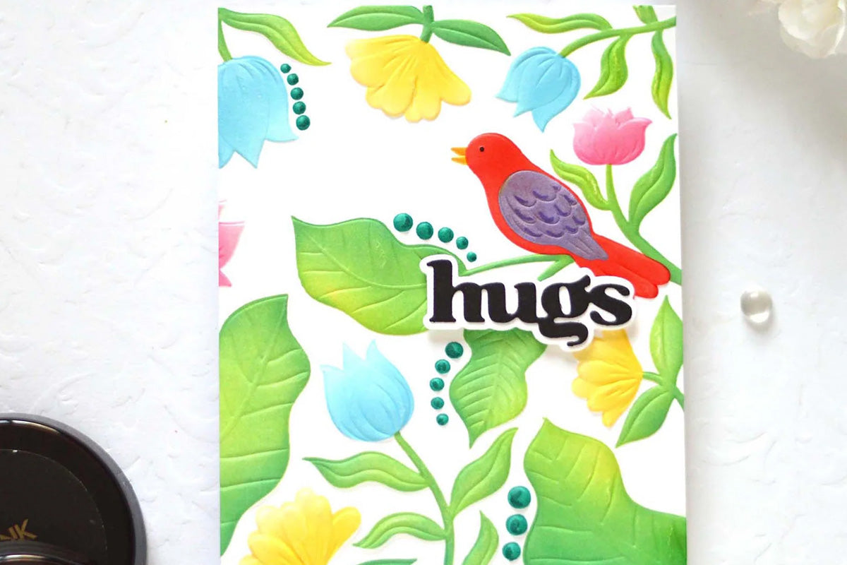 A colorful greeting card with a nature-themed backdrop, enhanced with Altenew's Versatile Greetings Die and Hot Foil Plate set