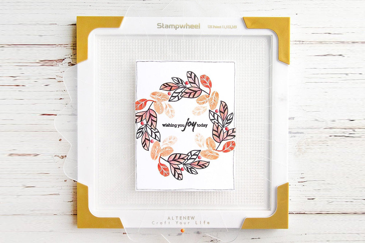 A wreath-decorated card created with the help of Altenew's Ultimate Stampwheel & Accessories Bundle