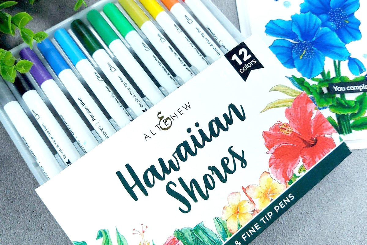 Altenew's Hawaiian Shores Dual Tip Pens (Water-based) beside a greeting card with a blue flower as a focal point
