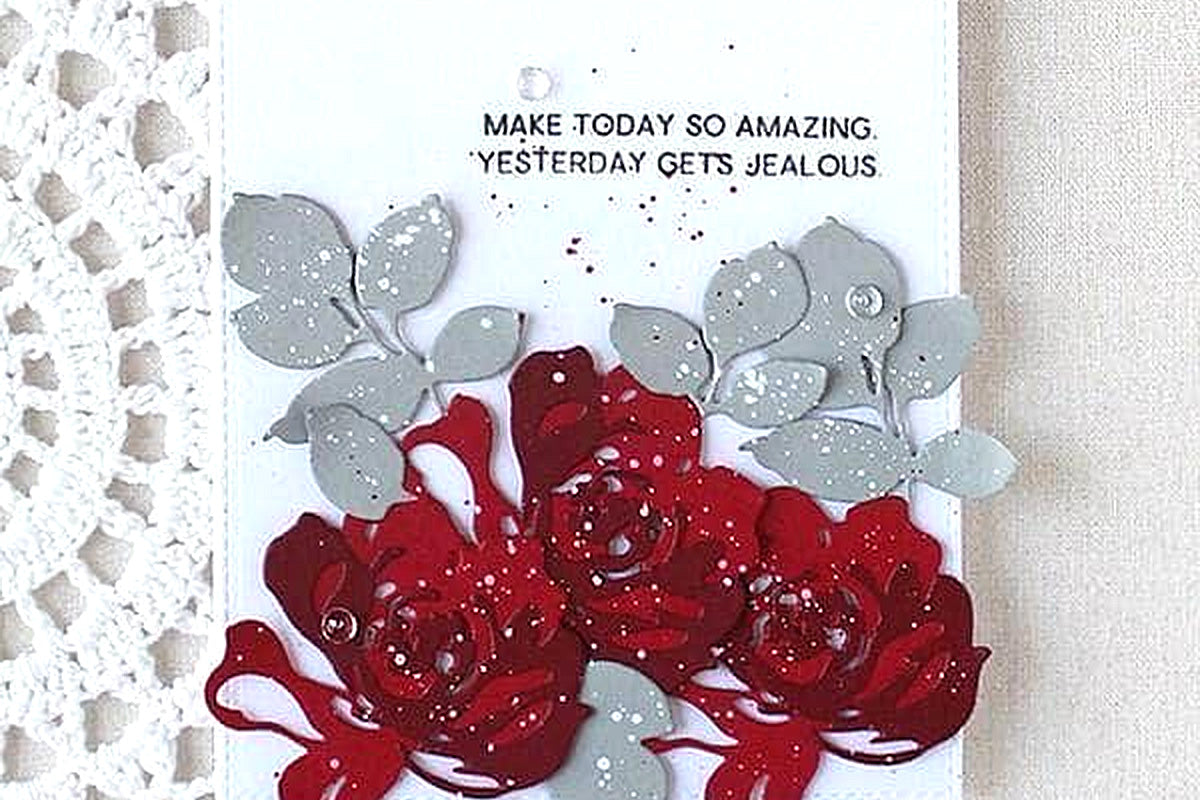 Red 3D flowers and leaves on a DIY greeting card