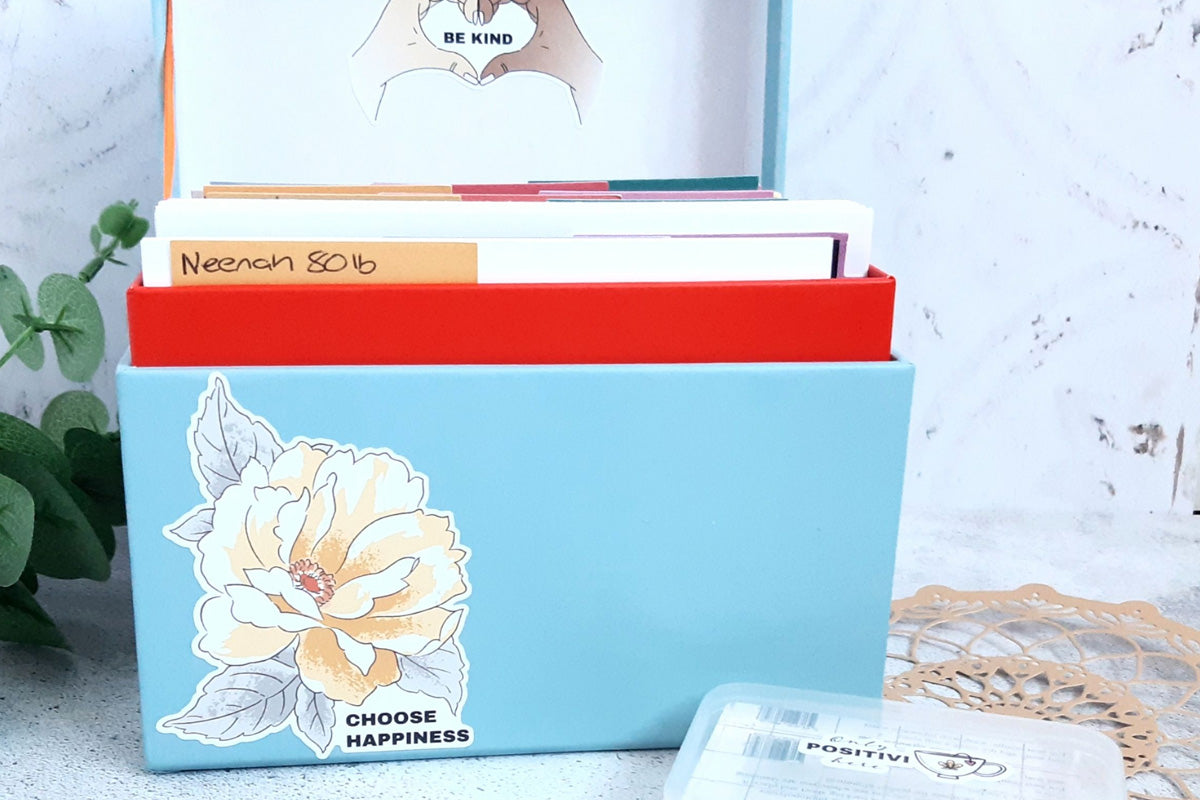 An upcycled box used as craft room storage for paper and cardstock