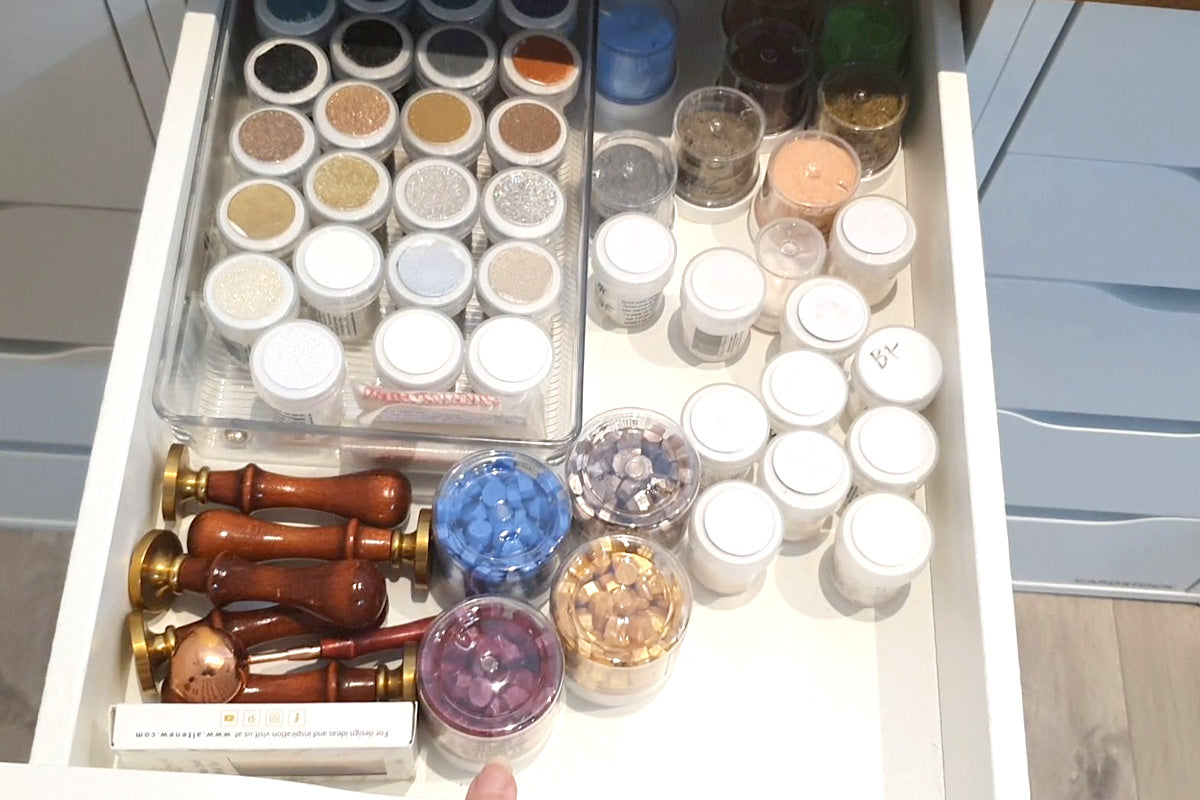 Altenew embossing powders, wax seal beads, and wax seal stamps stored in a drawer