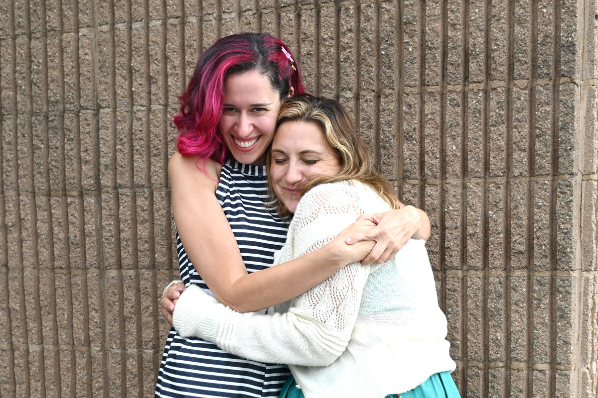 Altenew team members Jen Rzasa and Lydia Evans sharing a sweet hug.