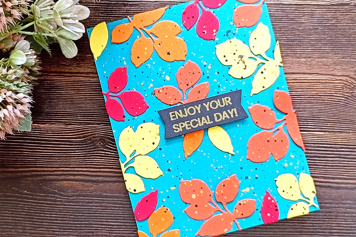 Motivational DIY greeting card with a blue background and colorful leaf die-cuts