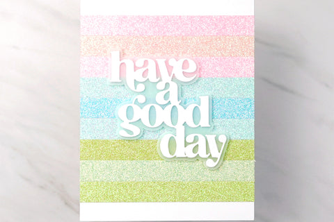 Rainbow handmade card with colorful glittered cardstock strips and the sentiment "have a good day"