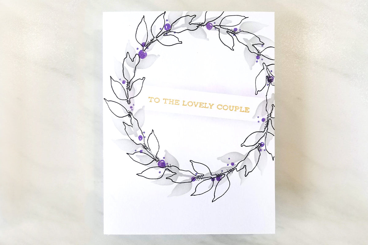 Clean, simple, and elegant wedding card idea with a simple leaf wreath