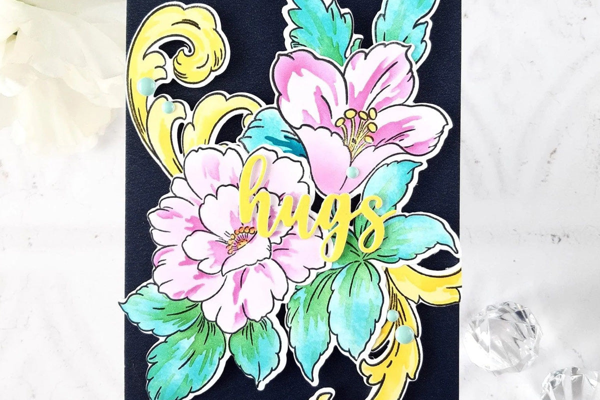 A beautiful card with dark background and the sentiment "hugs", created with the Craft Your Life Project Kit: Floral Acanthus using the One-Go Paper Crafting System