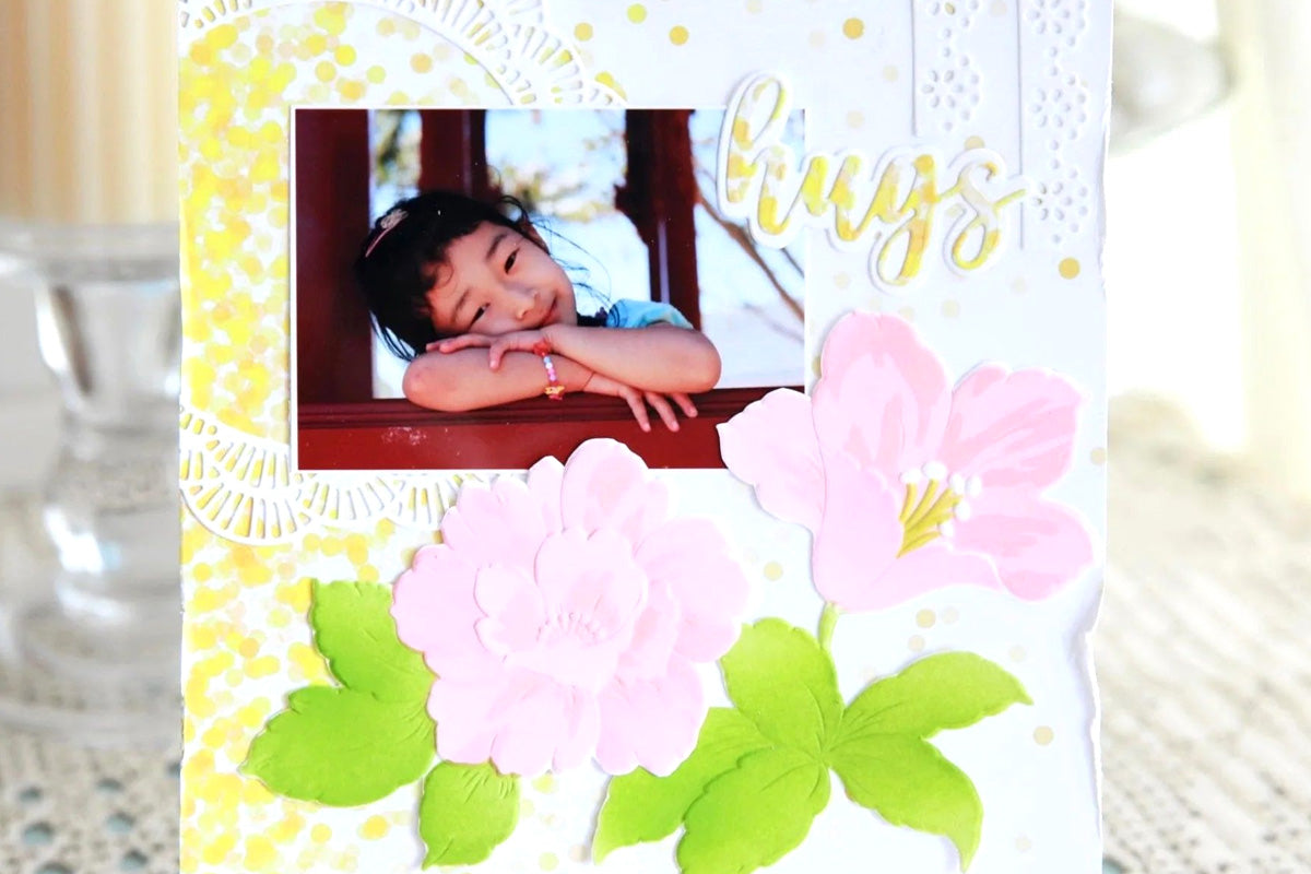 A photo card of a little girl with the sentiment "hugs", created with the Craft Your Life Project Kit: Floral Acanthus using the One-Go Paper Crafting System