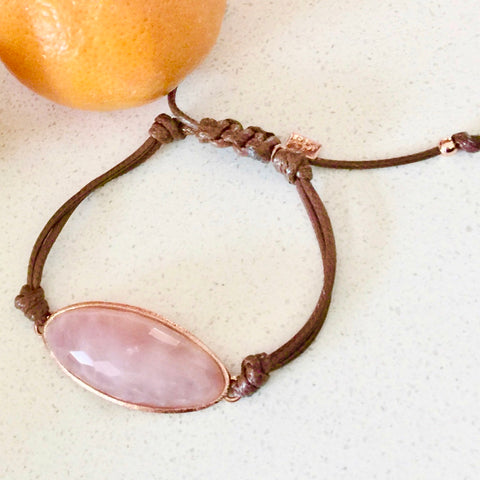 Lattice Corded Friendship Bracelet in Rose Quartz on a white table next to a lemon