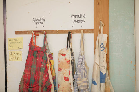 Potter's aprons hanging in a pottery studio