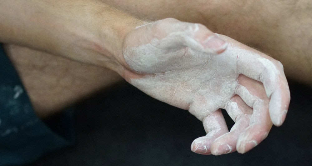 A climbers hand covered in liquid chalk