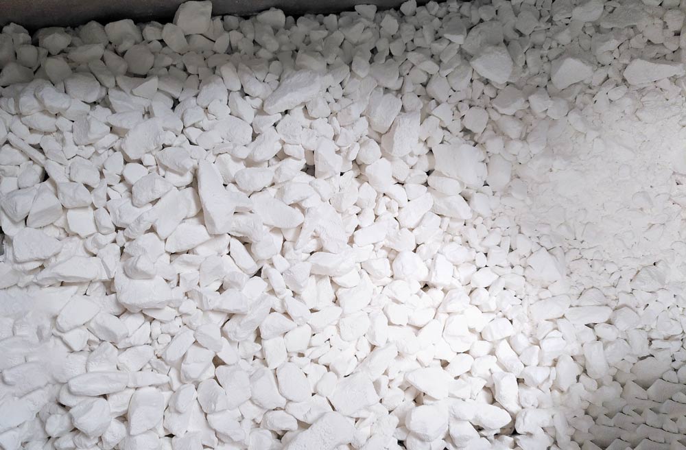 A close up of a box filled with lumps of white magnesium carbonate climbing chalk