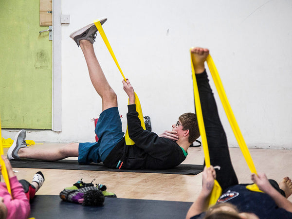 rock climbing resistance bands being used to warm up for indoor bouldering 