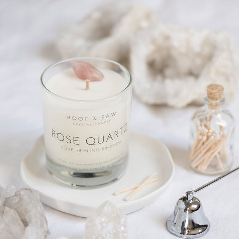 Rose Quartz candle set up with crystals surrounding it 