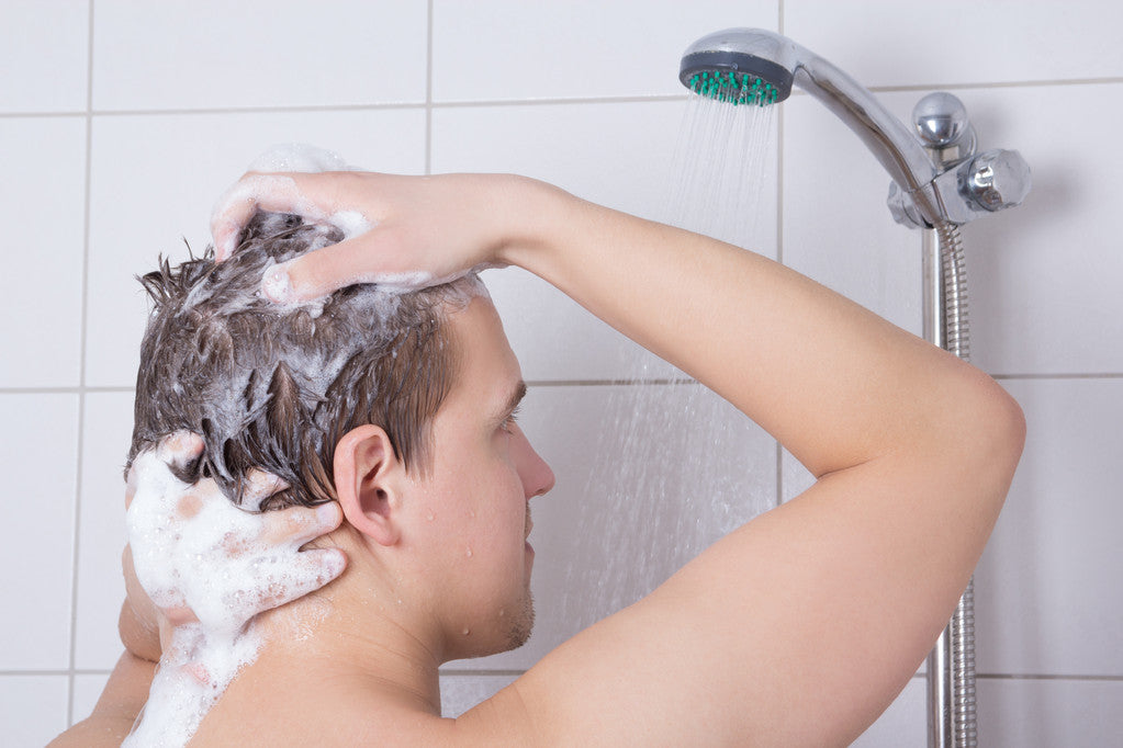 man showering his hair