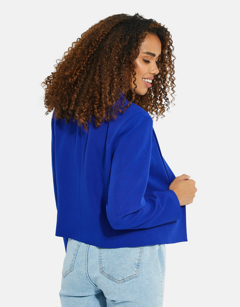 Woman wearing Threadbare Cobalt Blue Cropped Short Length Blazer and light wash denim jeans