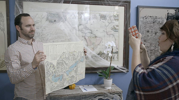 Sammy Berk of New World Cartographic holding a map that sold as a gift.