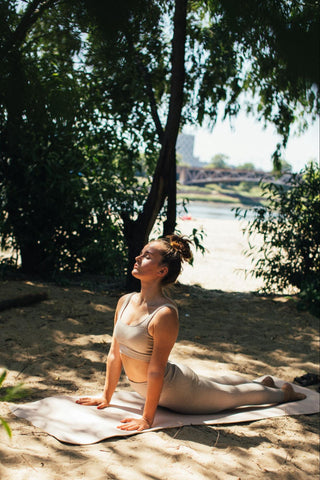 Girl performing upward facing dog as part of a 10 minute stretch routine.