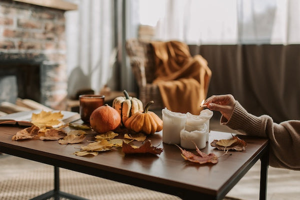 A Person Lighting Candles on a Coffee Table