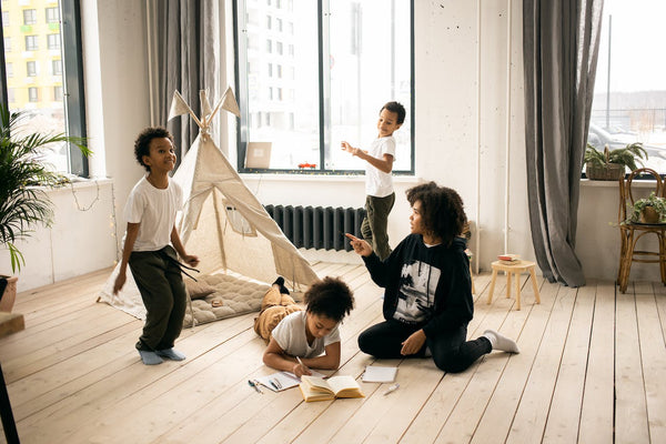Mother with children playing in room