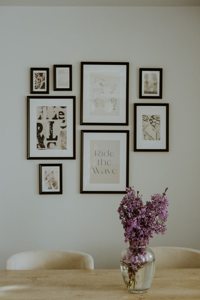 Dining Room with Bunch of Lavender in Vase and a group of prints on the wall