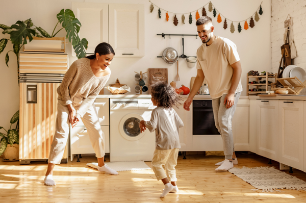 Parents playing with their child in the kitchen