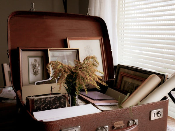 Vintage suitcase with photo frames and papers