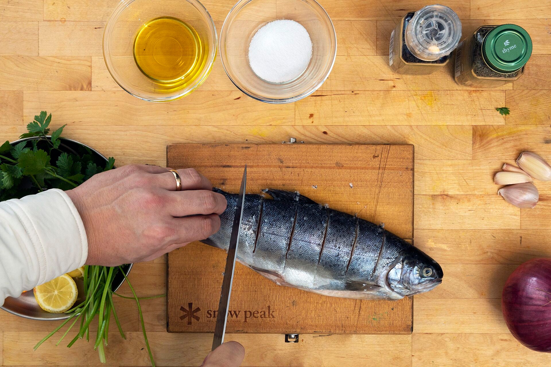 Scoring trout in preparation for grilling