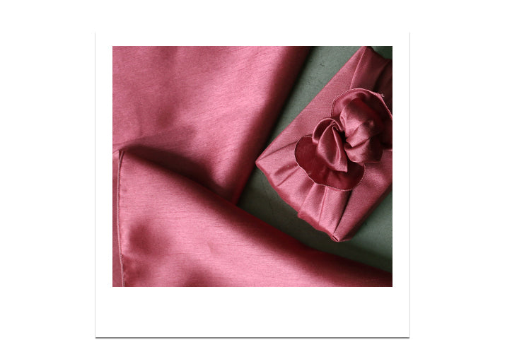 An up close look at the dark crimson gift wrapping cloth.