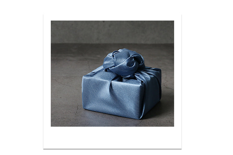 Reusable gift wrap is great because you can save it from a Doljanchi and use it for Christmas, and blue is a very neutral color that adds flair to any event.