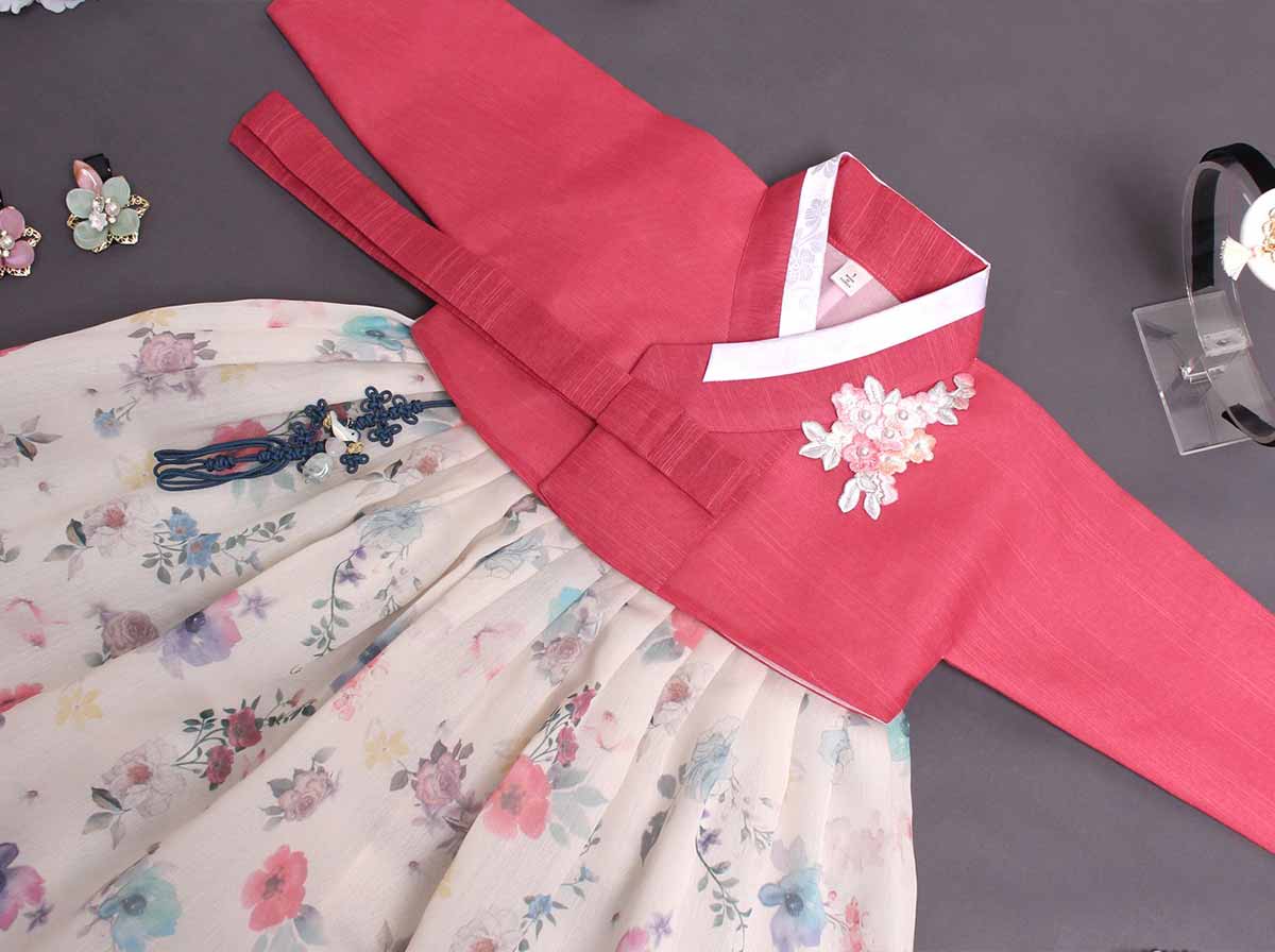 The floral baby girl hanbok in cherry red and cream is so traditionally Korean and authentic to the culture of Korea.