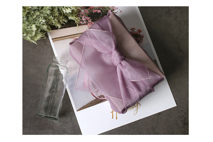 A big lovely bow adorns the top of this perse luxury gift wrap.